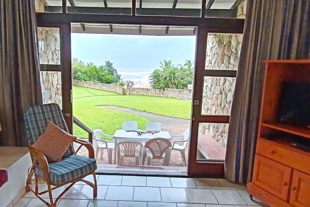 Patio view of garden with outdoor seating area.